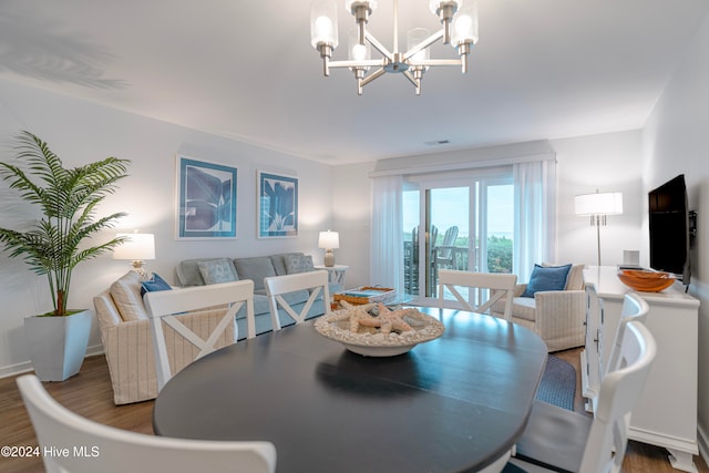 dining area with a chandelier and dark hardwood / wood-style flooring