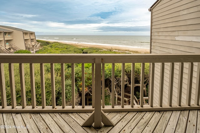 deck featuring a water view and a view of the beach