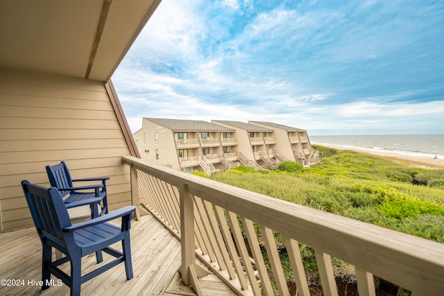 balcony with a beach view and a water view