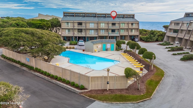 view of swimming pool with a water view