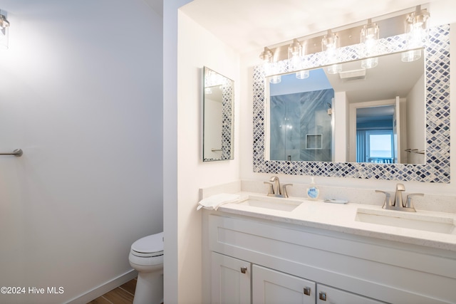 bathroom with vanity, hardwood / wood-style flooring, toilet, and walk in shower