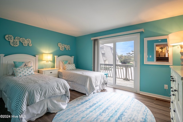 bedroom featuring access to exterior and dark wood-type flooring