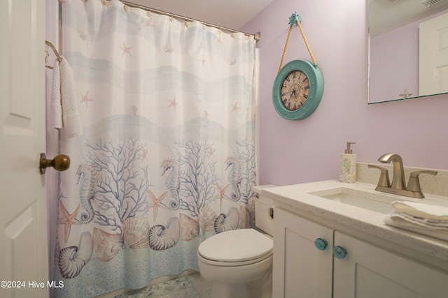 bathroom featuring a shower with curtain, vanity, and toilet