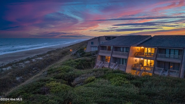 back house at dusk with a water view