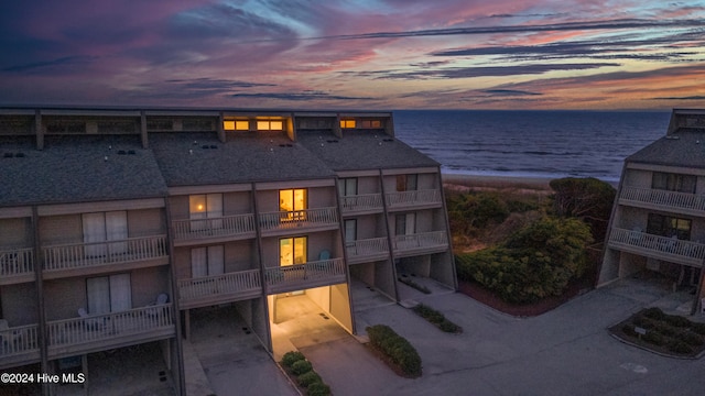 exterior space with a water view and a view of the beach