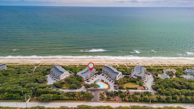 bird's eye view featuring a water view and a beach view