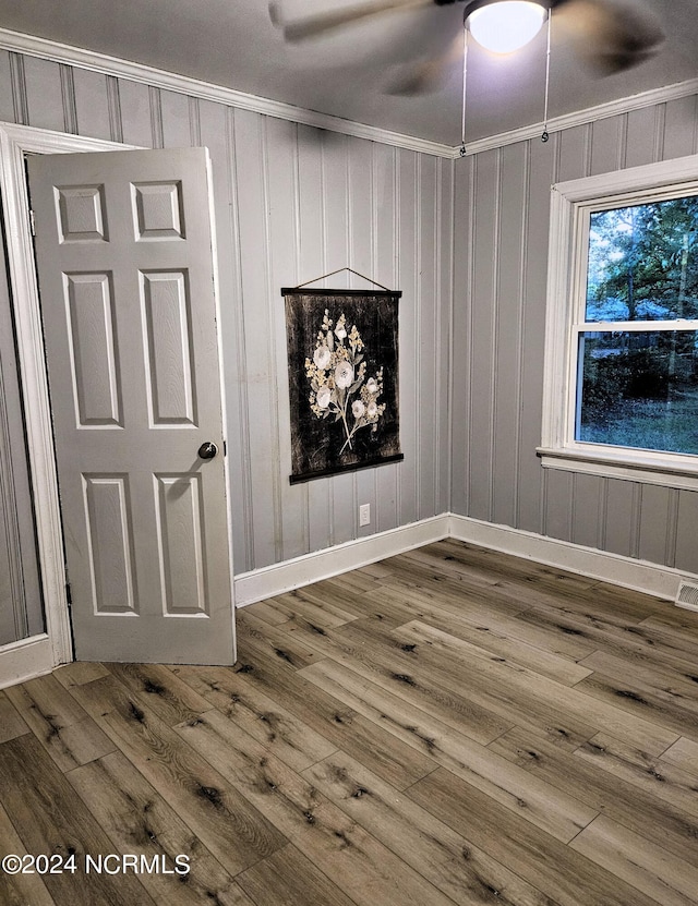 empty room with hardwood / wood-style floors, ceiling fan, and ornamental molding