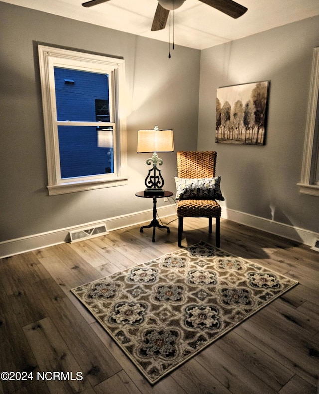 living area with hardwood / wood-style flooring and ceiling fan