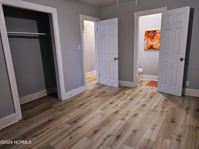 unfurnished bedroom featuring light hardwood / wood-style floors and a closet