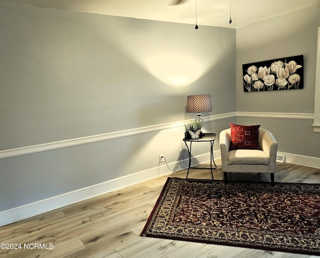 sitting room with hardwood / wood-style flooring