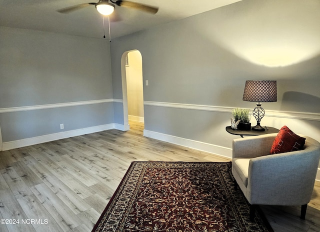 sitting room with hardwood / wood-style flooring and ceiling fan