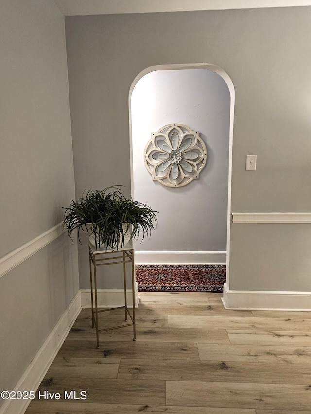 interior space featuring baseboards and wood finished floors