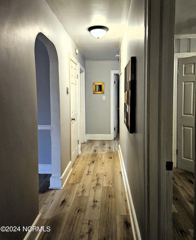 corridor with light hardwood / wood-style floors