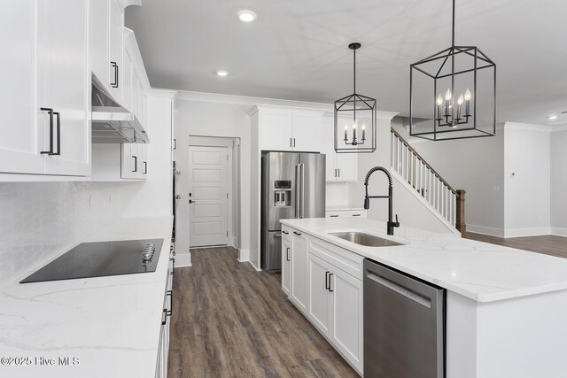 kitchen featuring decorative light fixtures, white cabinetry, stainless steel appliances, sink, and dark hardwood / wood-style floors