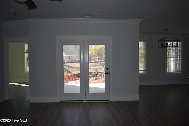 entryway with ceiling fan, a wealth of natural light, and ornamental molding