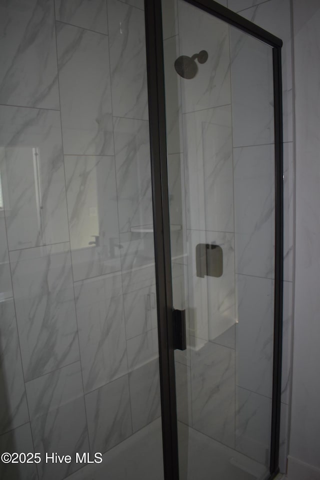 bathroom with a shower with shower door