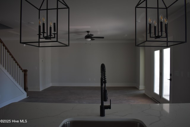 stairs featuring ceiling fan, sink, and french doors