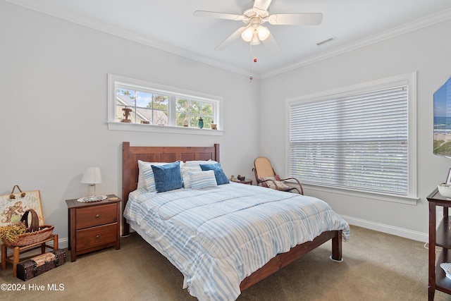 carpeted bedroom featuring ceiling fan and ornamental molding