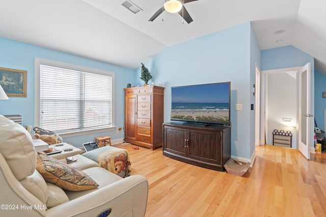 living room with light hardwood / wood-style flooring, ceiling fan, and lofted ceiling