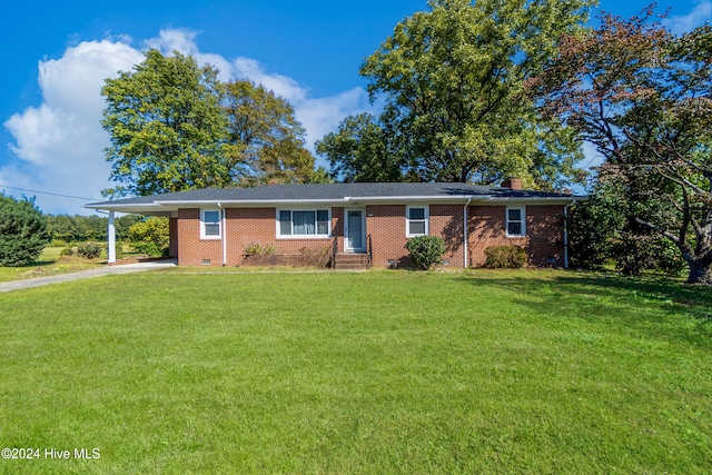 ranch-style home featuring a carport and a front yard