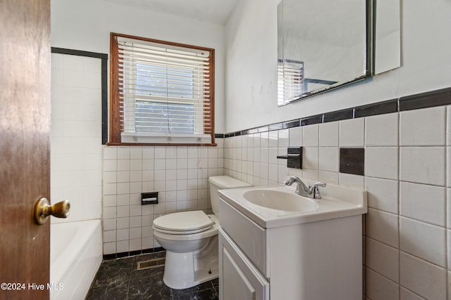 bathroom featuring a bathing tub, tile walls, vanity, and toilet