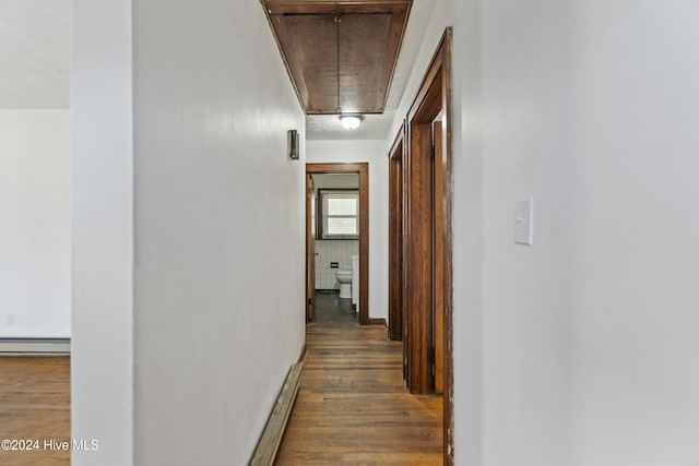 corridor with hardwood / wood-style flooring