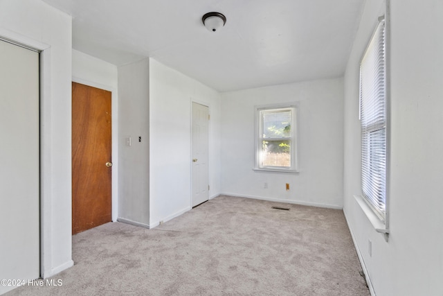 unfurnished bedroom featuring light colored carpet