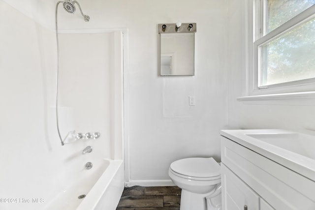 full bathroom with hardwood / wood-style flooring, toilet, vanity, and  shower combination