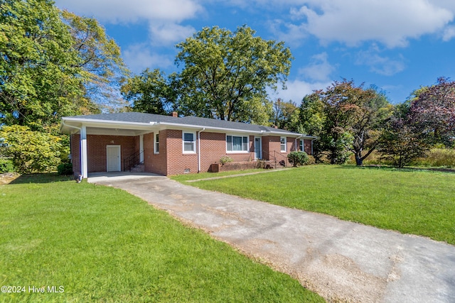 ranch-style home featuring a carport and a front yard