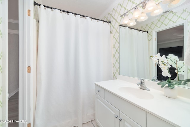 bathroom featuring crown molding and vanity