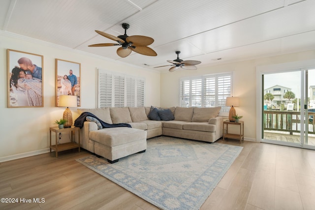 living room featuring ceiling fan, crown molding, and wood-type flooring