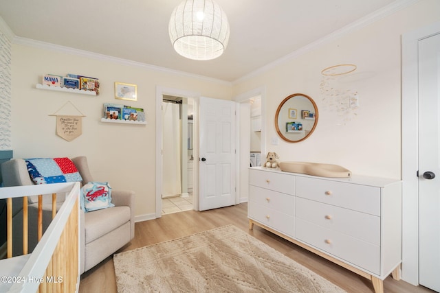 bedroom featuring ornamental molding and light hardwood / wood-style floors