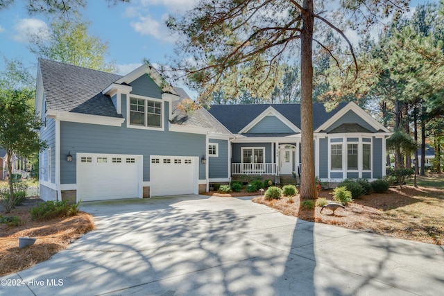 view of front facade featuring a porch and a garage