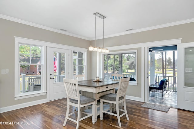 dining space with a wealth of natural light, crown molding, and dark wood-type flooring