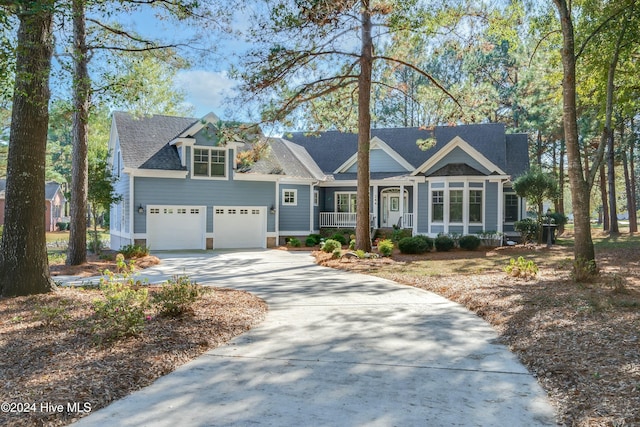 view of front of house with a porch and a garage