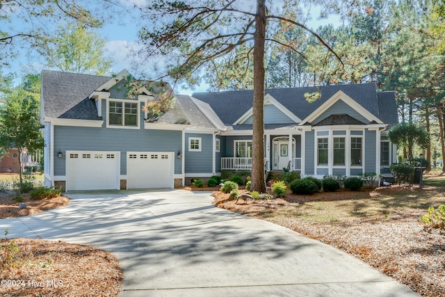 view of front of home featuring a porch and a garage