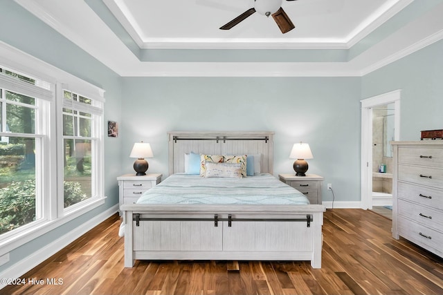 bedroom with dark hardwood / wood-style floors, ceiling fan, ensuite bathroom, and crown molding