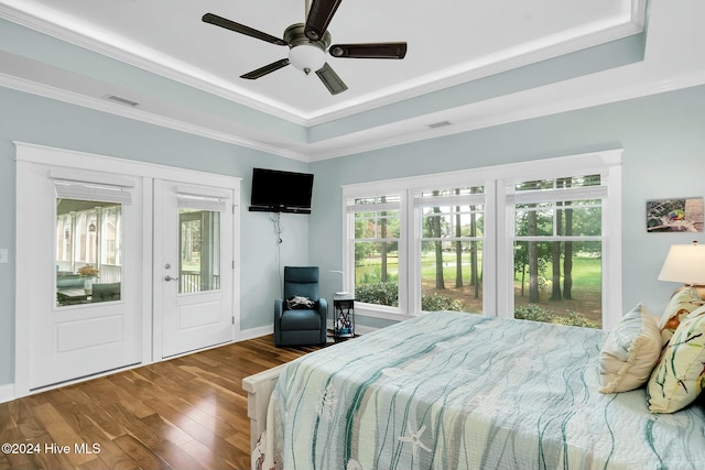 bedroom featuring hardwood / wood-style floors, access to outside, a raised ceiling, crown molding, and ceiling fan