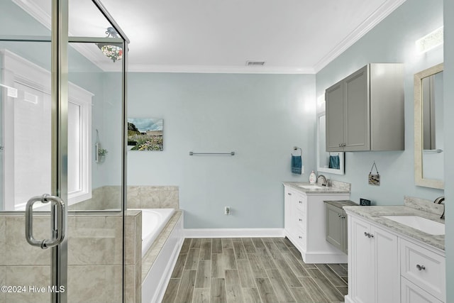 bathroom featuring vanity, wood-type flooring, ornamental molding, and shower with separate bathtub