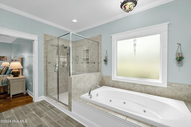 bathroom with crown molding and shower with separate bathtub