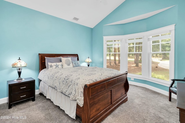 carpeted bedroom featuring high vaulted ceiling