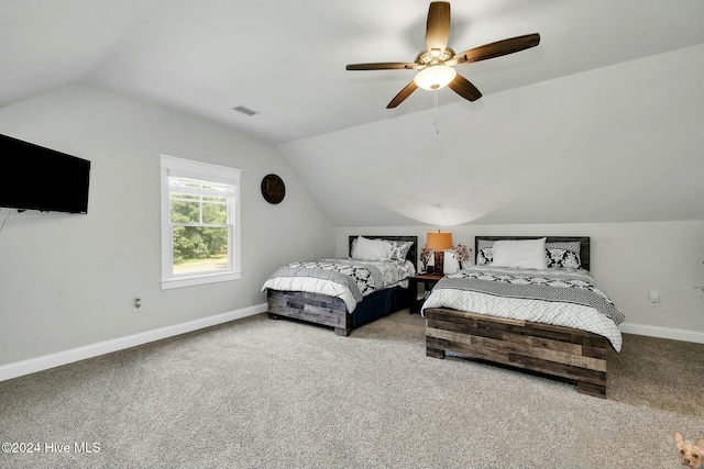 bedroom with ceiling fan, carpet floors, and vaulted ceiling