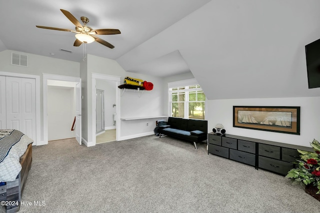 living area featuring ceiling fan, lofted ceiling, and carpet floors