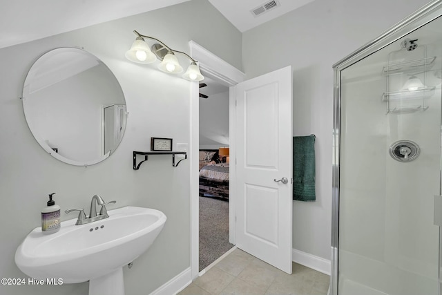 bathroom featuring tile patterned floors, a shower with shower door, and sink