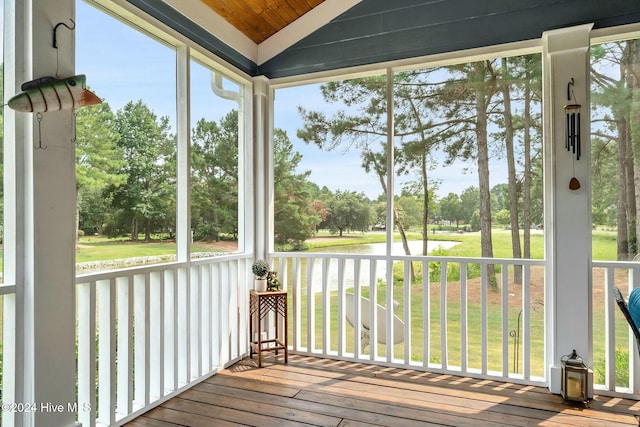 unfurnished sunroom featuring a water view, wood ceiling, and vaulted ceiling