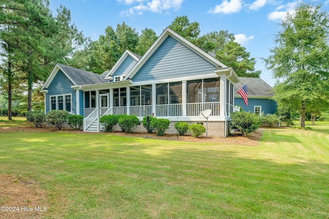 back of property featuring a sunroom and a yard