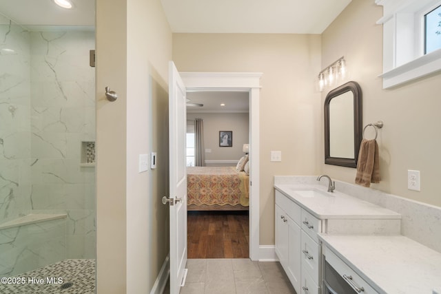 ensuite bathroom featuring a marble finish shower, vanity, recessed lighting, and connected bathroom