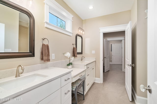 full bathroom featuring a sink, baseboards, recessed lighting, and double vanity