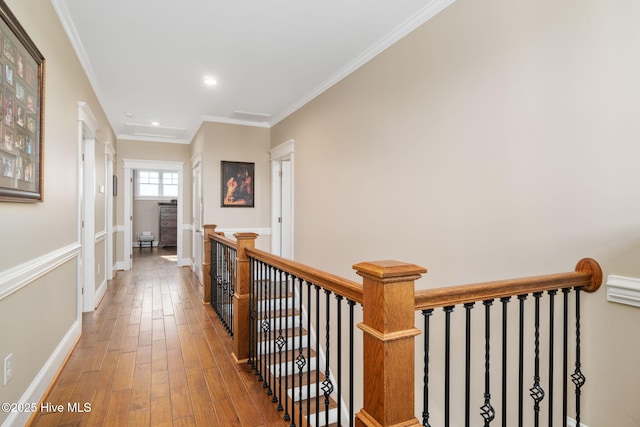 hall featuring crown molding, recessed lighting, baseboards, an upstairs landing, and wood finished floors