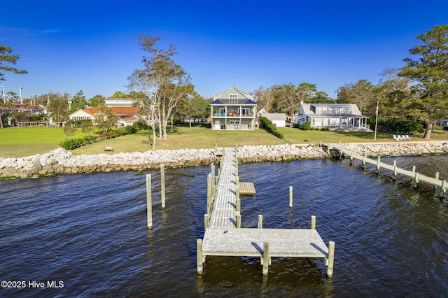 dock area with a water view and a yard